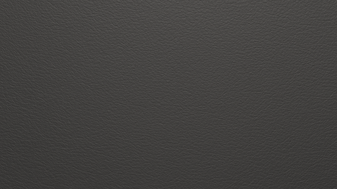 Charcoal vegan microfibre leather texture in a detailed close-up, showing the refined grain and durable surface.