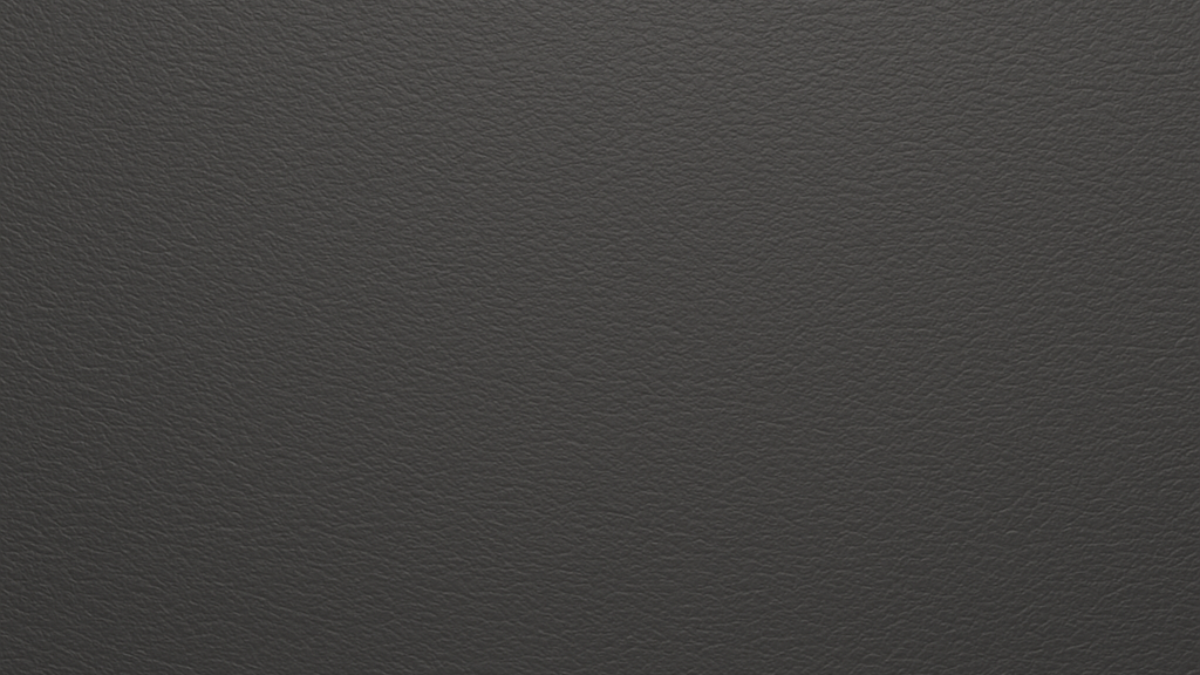 Charcoal vegan microfibre leather texture in a detailed close-up, showing the refined grain and durable surface.